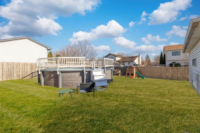 a view of a house with swimming pool and sitting area