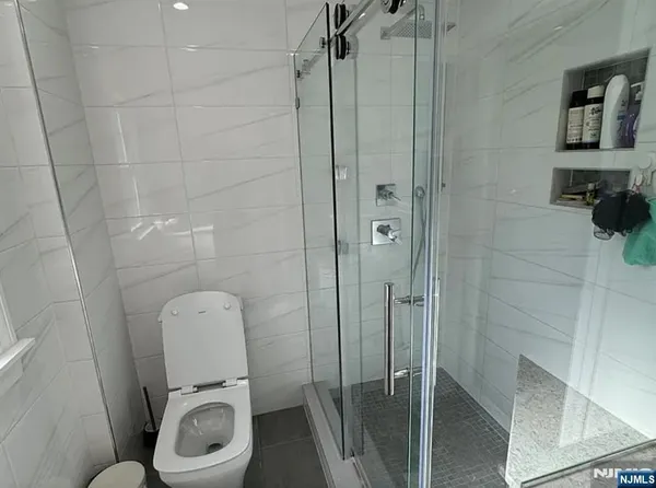 a bathroom with a toilet and a shower
