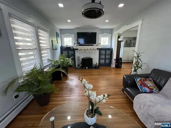 a living room with furniture fireplace and flat screen tv