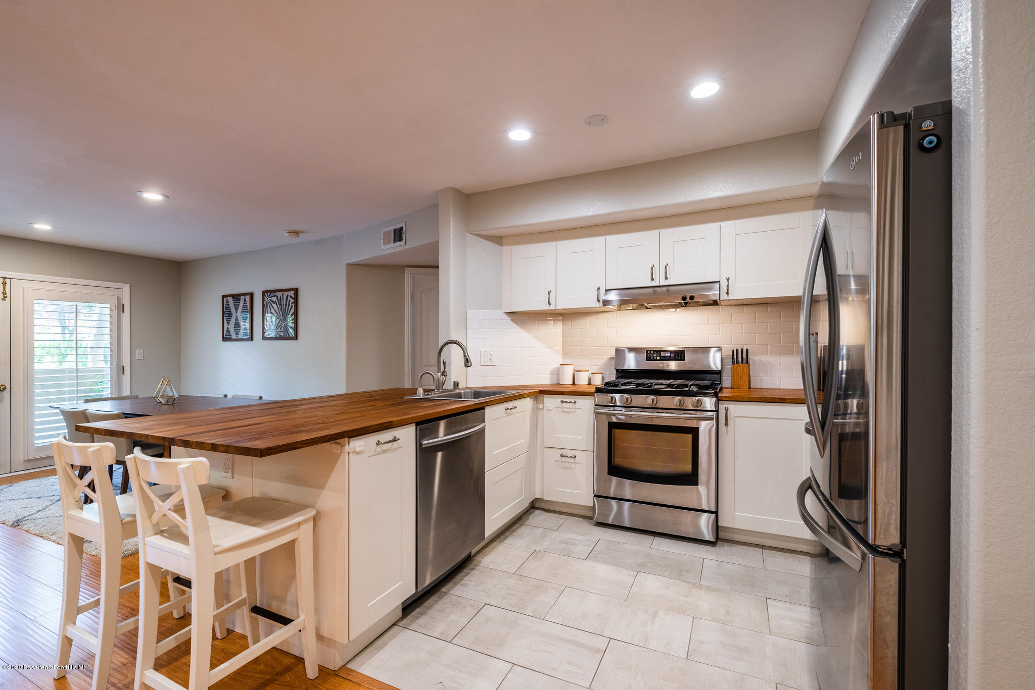 6140 Monterey Road, Unit 328 Los Angeles, CA 90042 - Photo 2 of 28 a kitchen with stainless steel appliances granite countertop a stove and a refrigerator