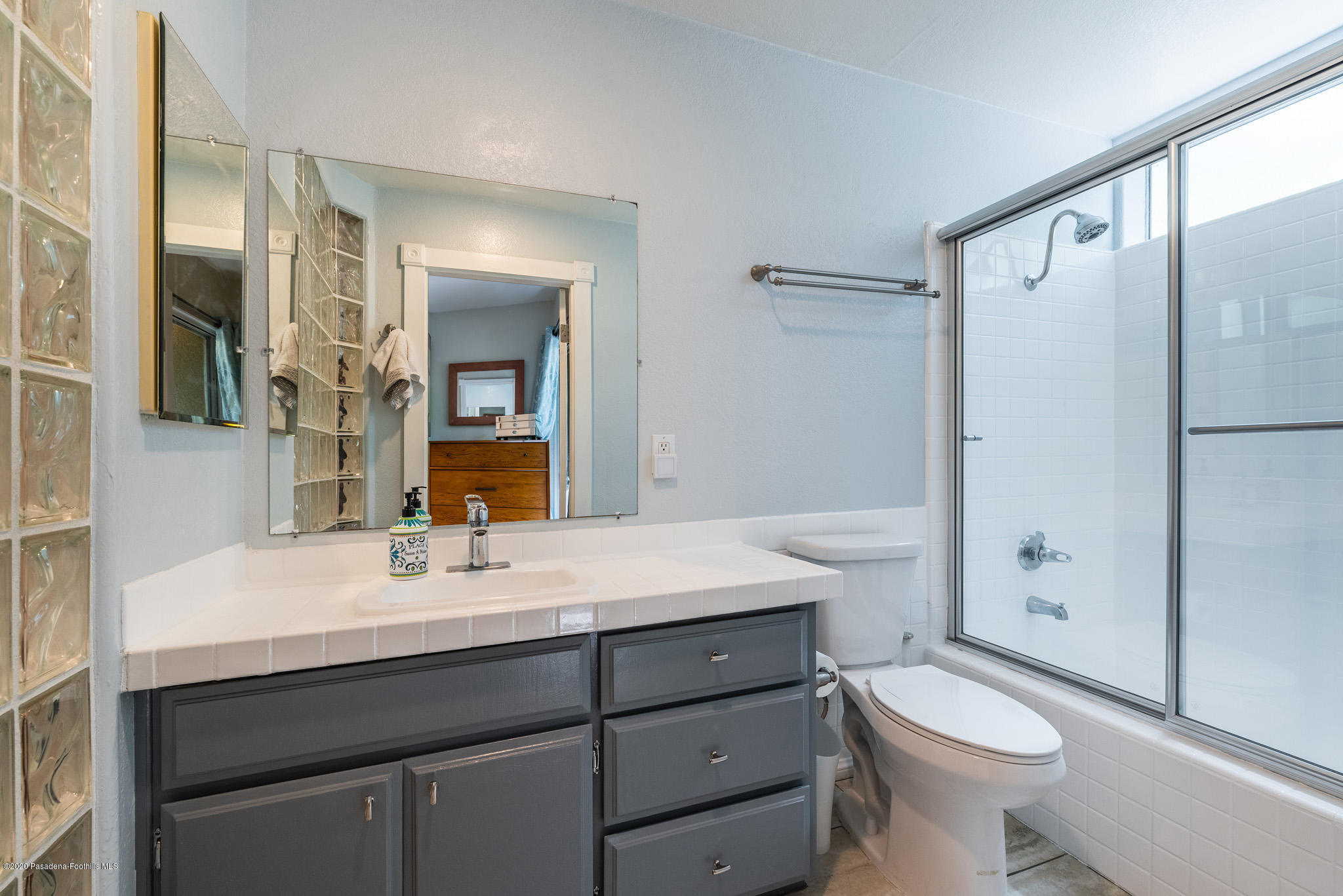 6140 Monterey Road, Unit 328 Los Angeles, CA 90042 - Photo 15 of 28 a bathroom with a sink a toilet a mirror and shower