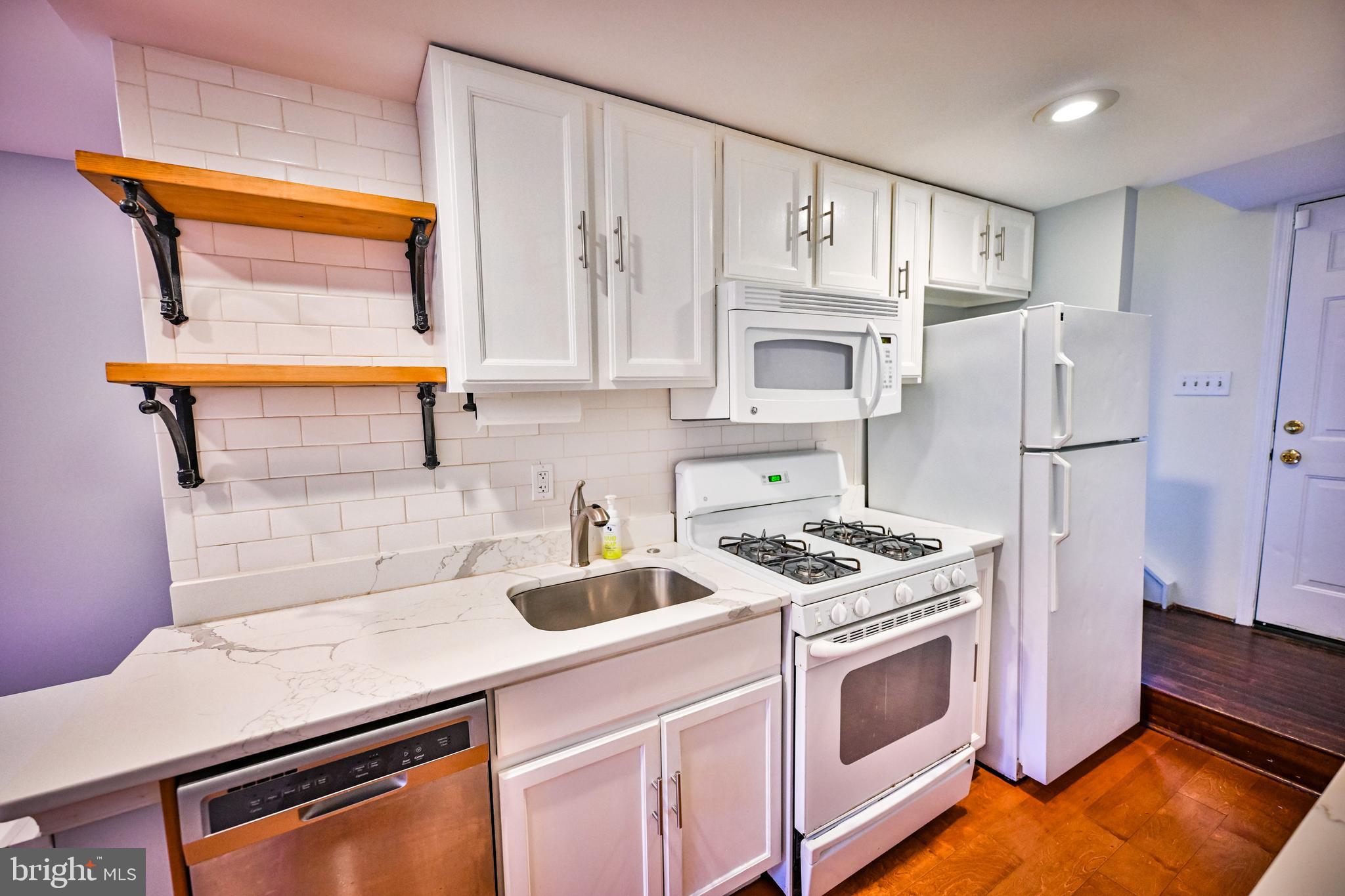 1601 Marshall Street Baltimore, MD 21230 - Photo 3 of 32 a kitchen with stainless steel appliances a stove a sink and a refrigerator