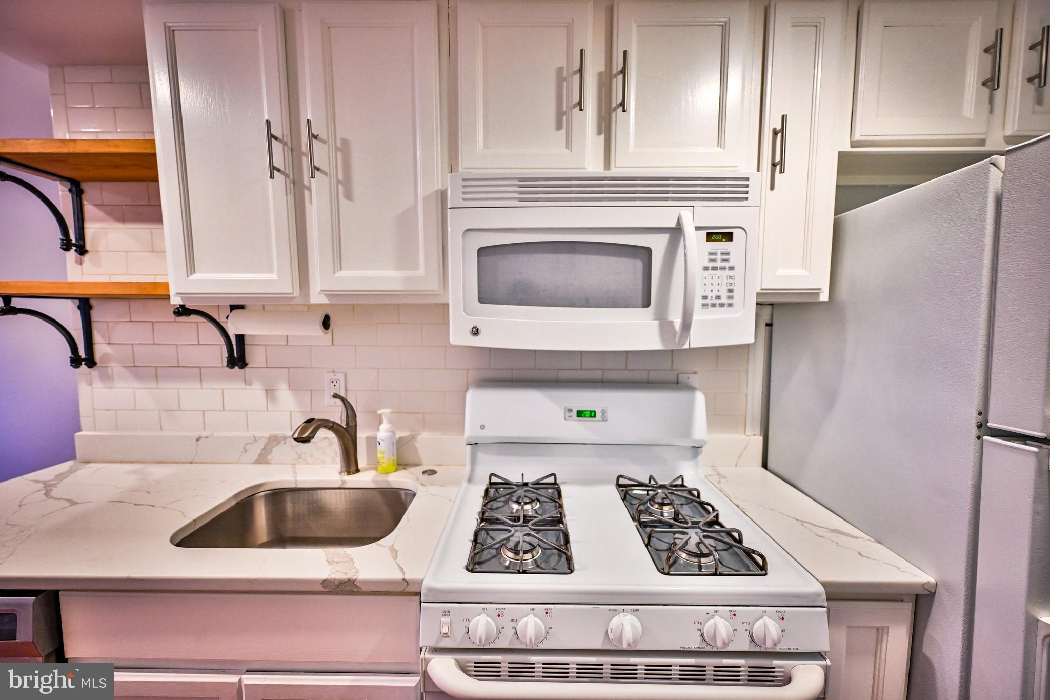 1601 Marshall Street Baltimore, MD 21230 - Photo 4 of 32 a kitchen with sink a refrigerator and cabinets