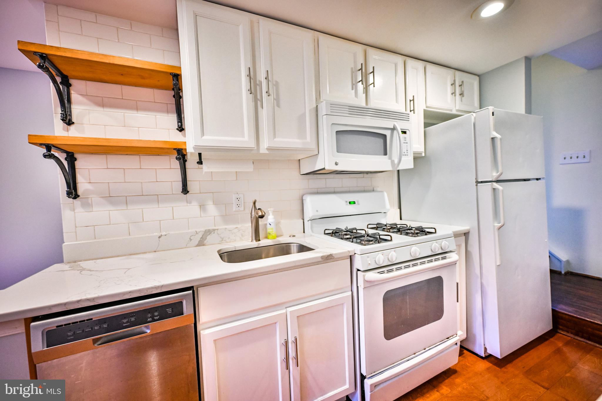 1601 Marshall Street Baltimore, MD 21230 - Photo 5 of 32 a kitchen with cabinets and steel stainless steel appliances