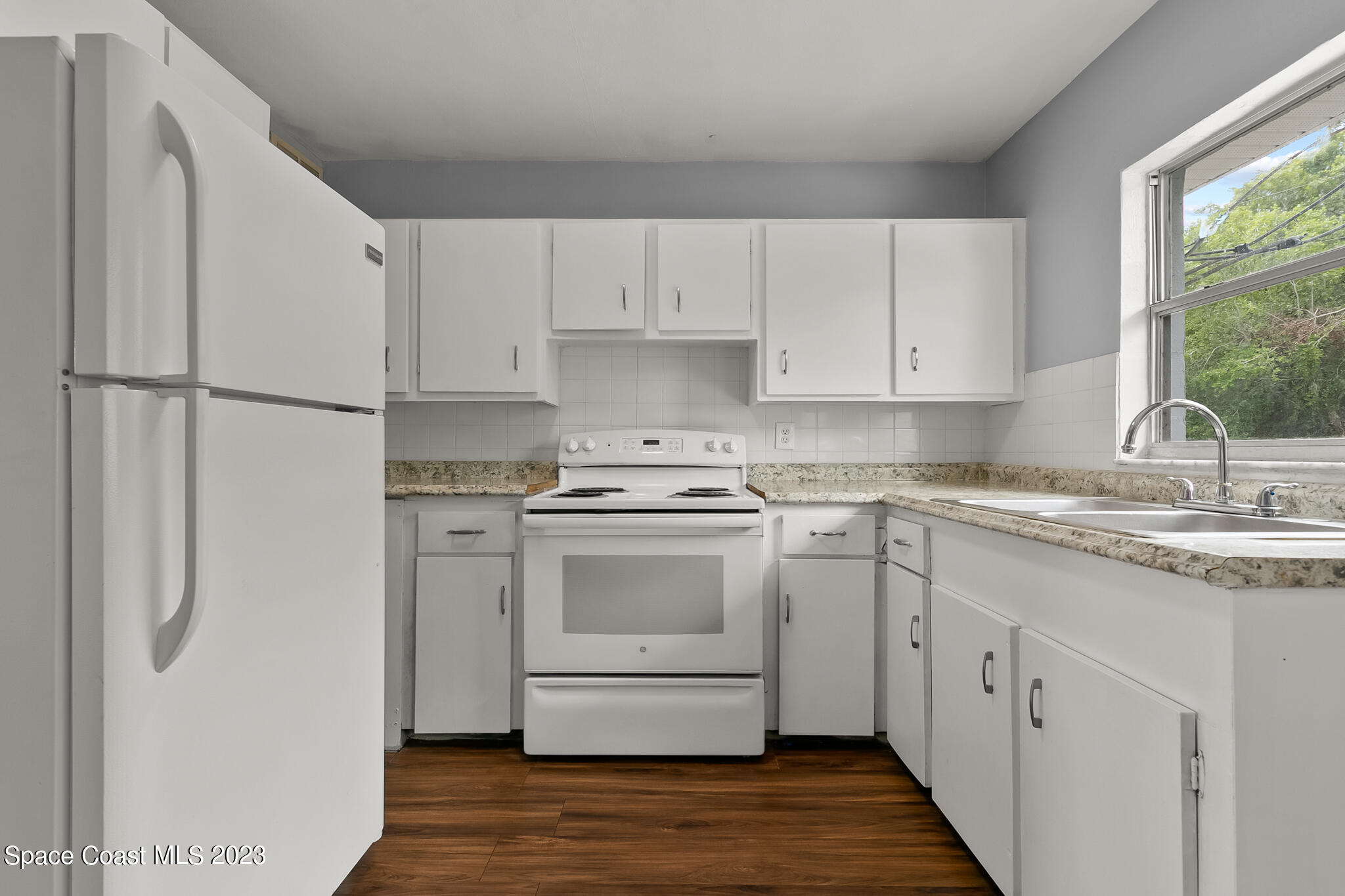 650 Dixon Boulevard, Unit B4 Cocoa, FL 32922 - Photo 13 of 21 a kitchen with white cabinets and white appliances