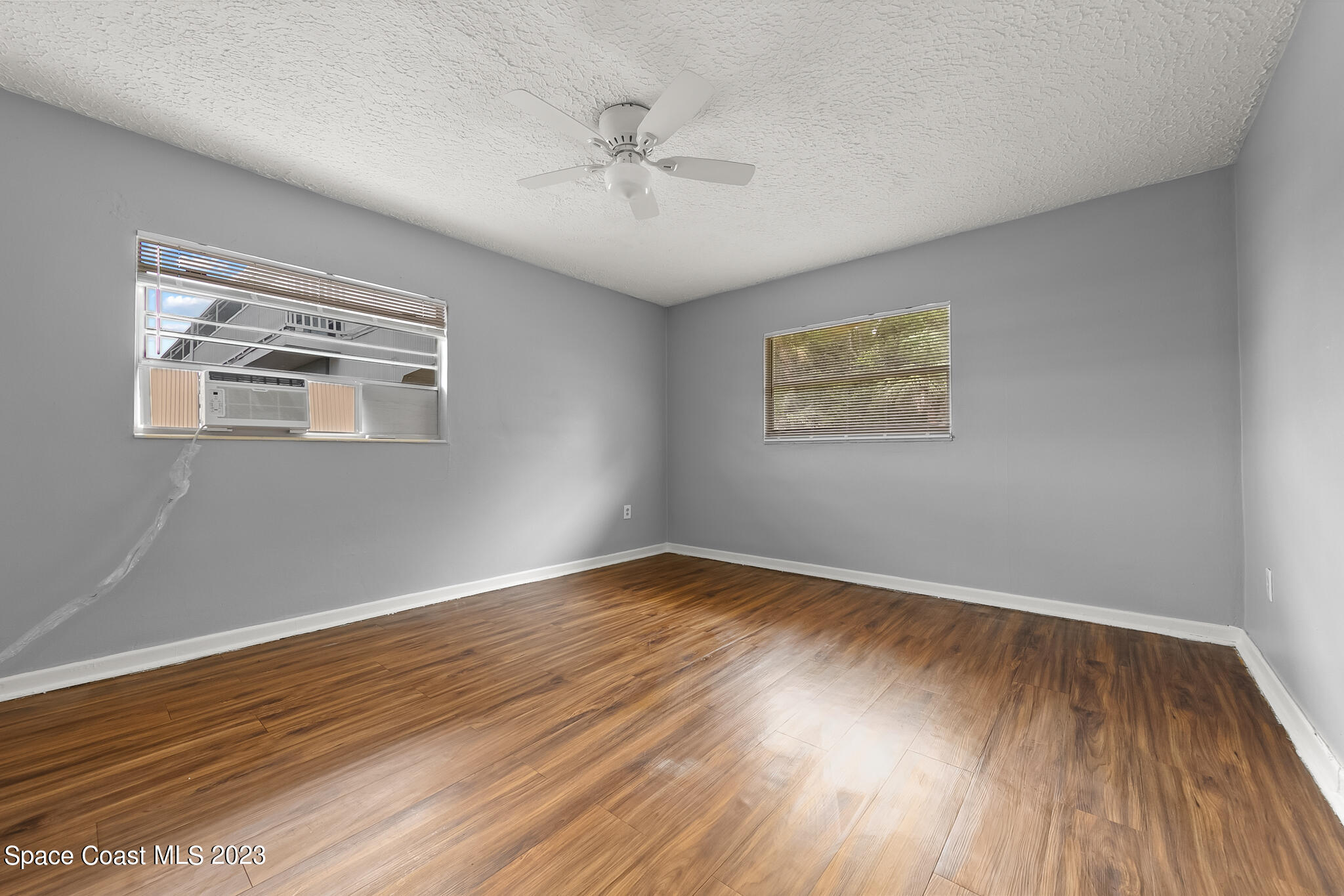 650 Dixon Boulevard, Unit B4 Cocoa, FL 32922 - Photo 17 of 21 a view of an empty room with wooden floor and a window