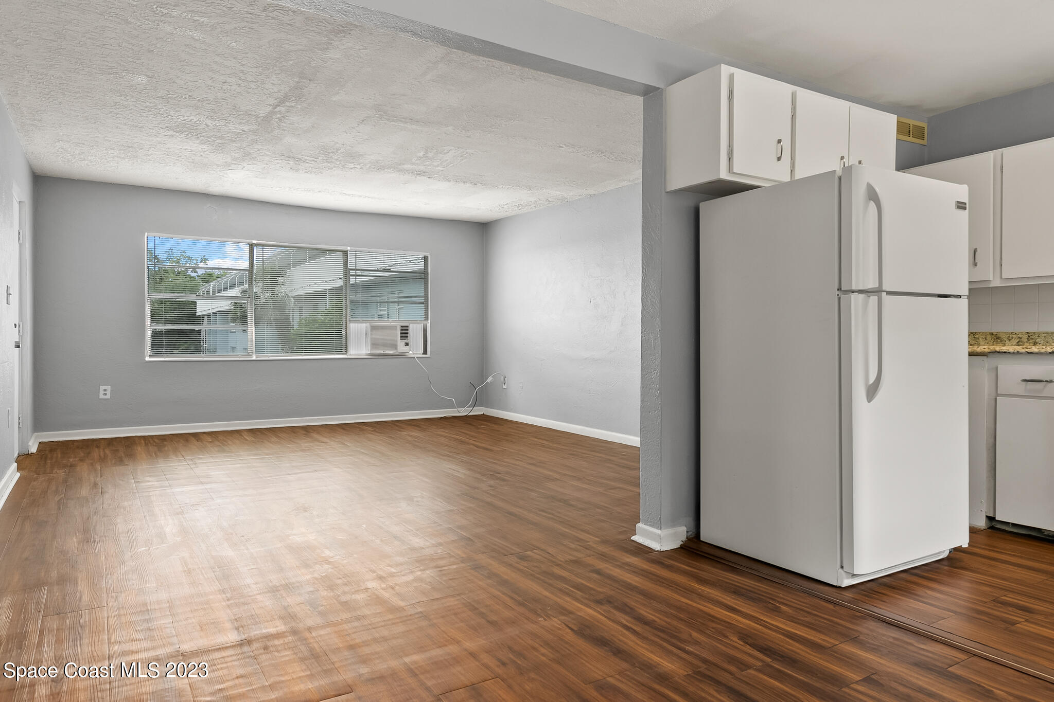 650 Dixon Boulevard, Unit B4 Cocoa, FL 32922 - Photo 9 of 21 a view of a kitchen with wooden floor and electronic appliances