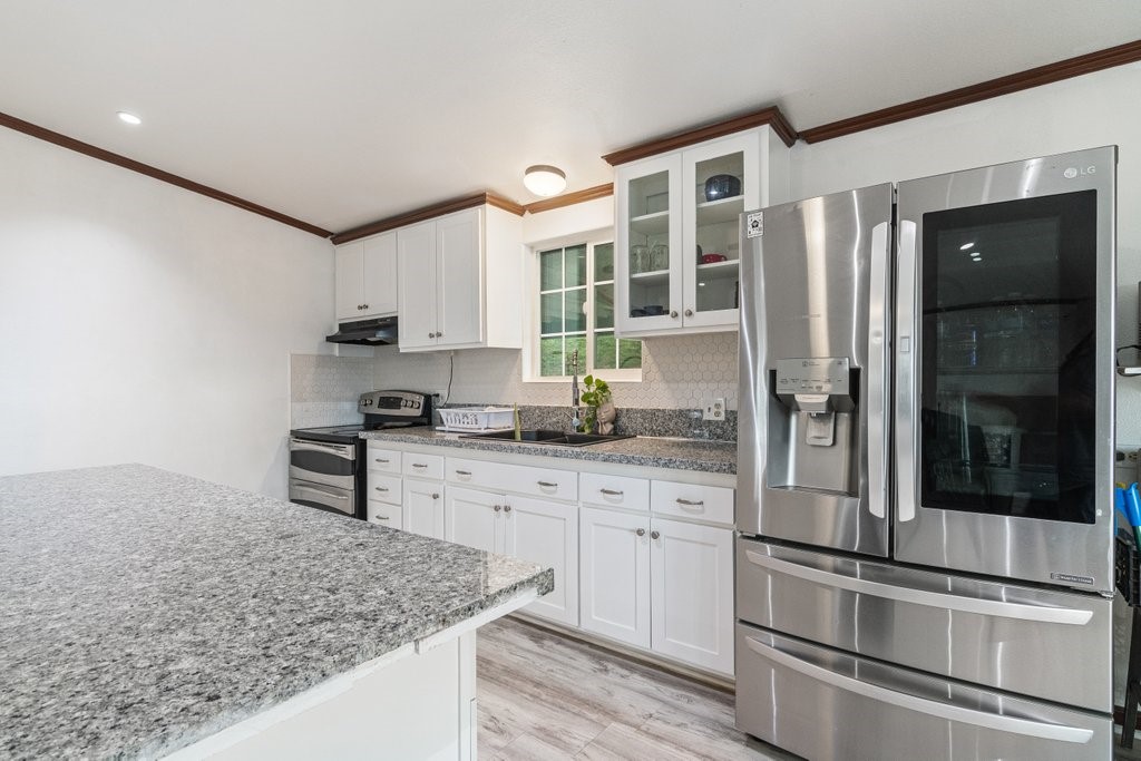 26460 Dale Street Hemet, CA 92545 - Photo 30 of 40 a kitchen with stainless steel appliances granite countertop a stove and a sink