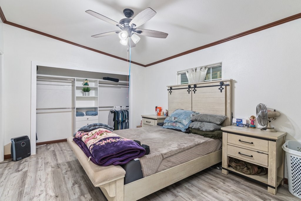 26460 Dale Street Hemet, CA 92545 - Photo 34 of 40 a bedroom with a bed chandelier and a window