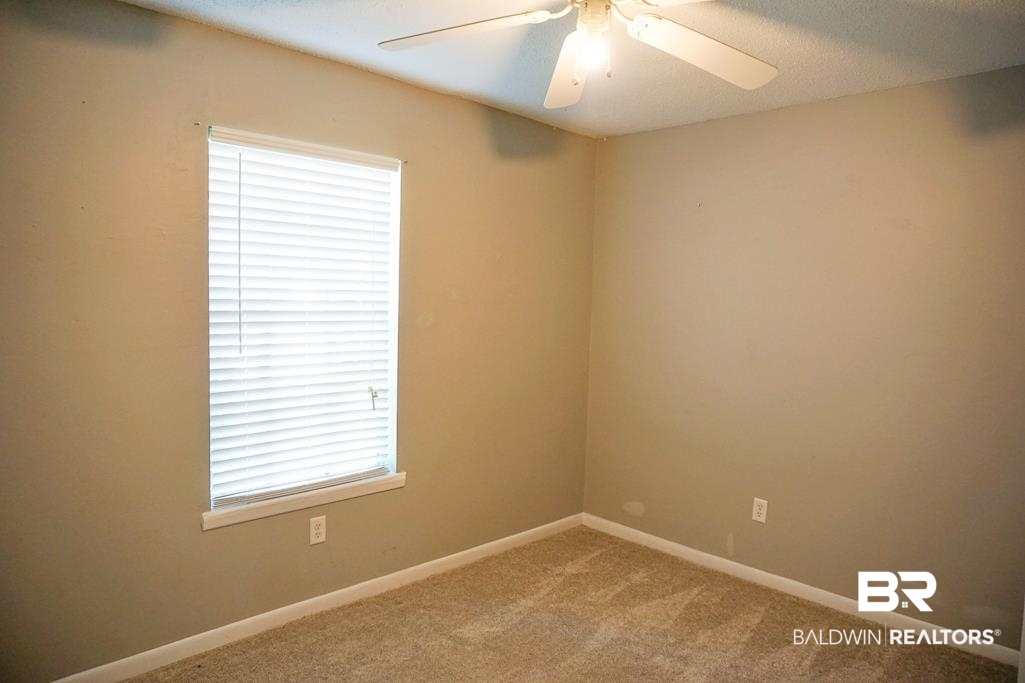 4366 Fathbrook Lane Mobile, AL 36693 - Photo 13 of 14 Unfurnished room with light carpet, a ceiling fan, and baseboards