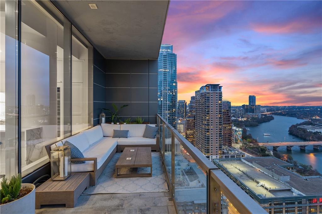 210 Lavaca Street, Unit 2706 Austin, TX 78701 - Photo 31 of 32 Expansive balcony featuring a glass railing, concrete flooring, and a panoramic cityscape with a river