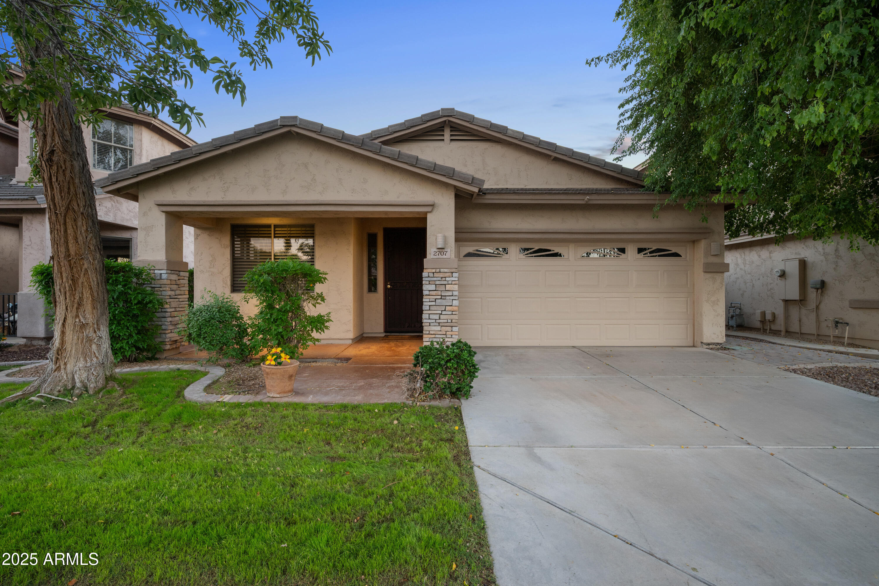 a front view of a house with a yard and garage