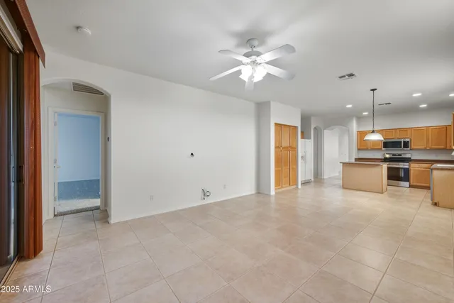 a view of an empty room with a kitchen