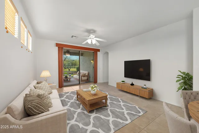 a living room with furniture and a flat screen tv
