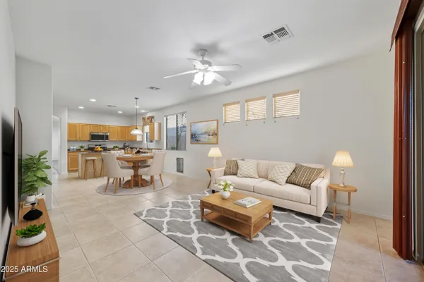 a living room with furniture and a view of kitchen