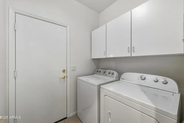 a view of storage and utility room with washer and dryer