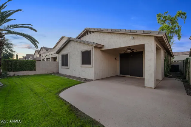 a view of a house with a backyard