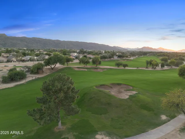 a view of a lush green outdoor space with a lake view