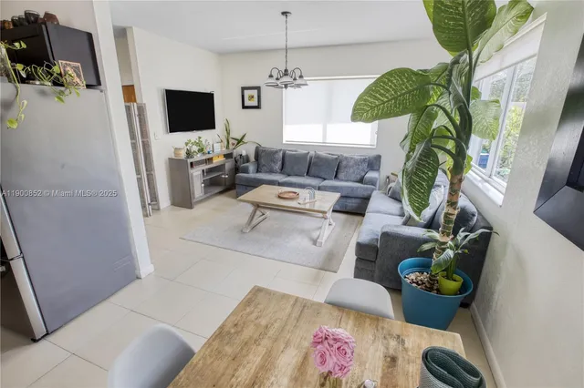 a living room with furniture and a potted plant