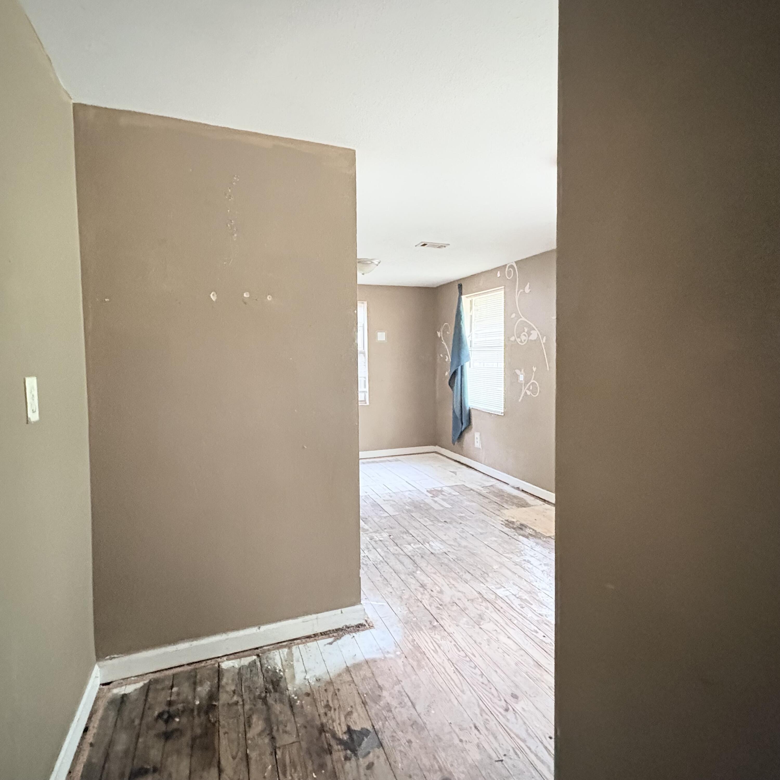 656 McClelland Street Crestview, FL 32536 - Photo 6 of 8 a view of hallway with wooden floor