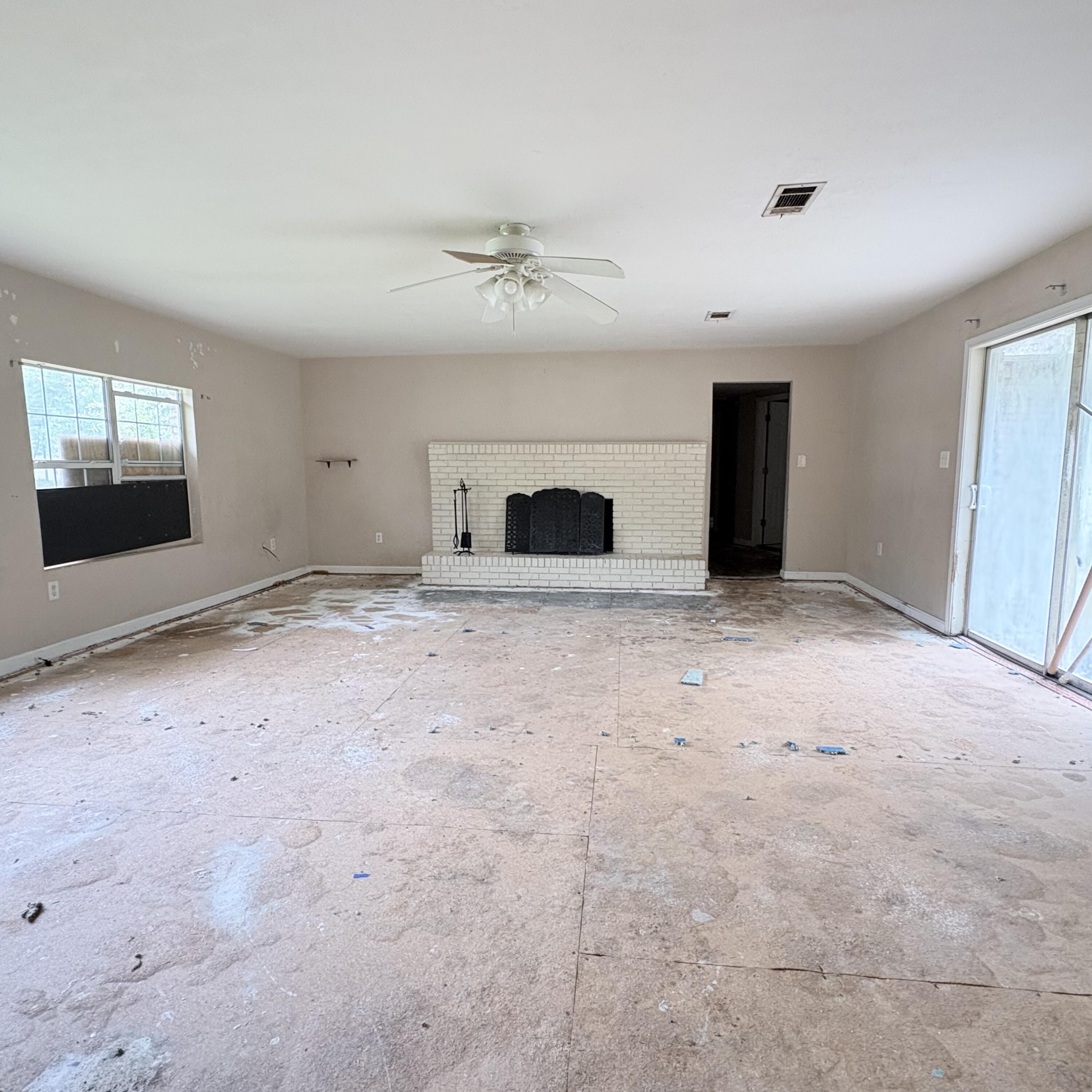 656 McClelland Street Crestview, FL 32536 - Photo 8 of 8 an empty room with windows and fireplace
