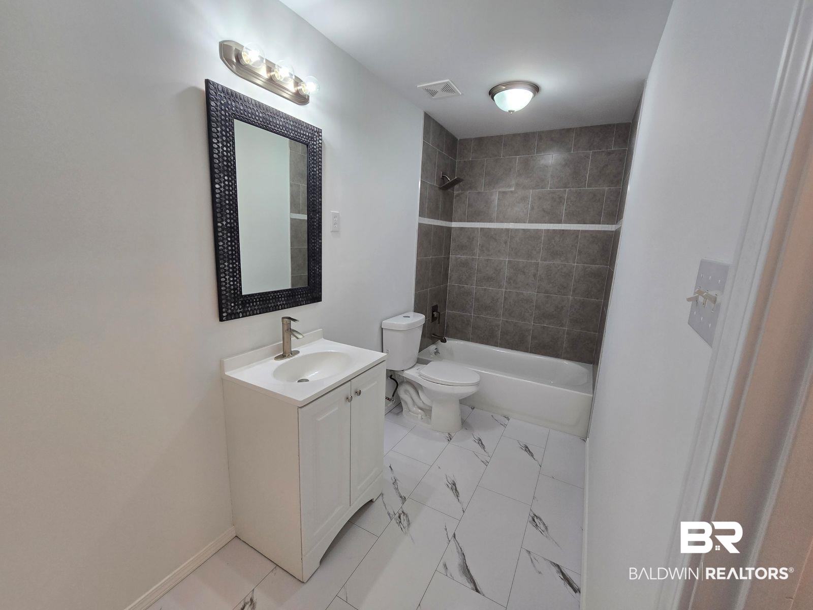 1600 Blair Road Brewton, AL 36426 - Photo 6 of 15 Full bathroom featuring vanity, toilet, and tiled shower / bath combo