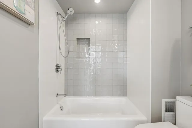 a bathroom with a bathtub and a shower