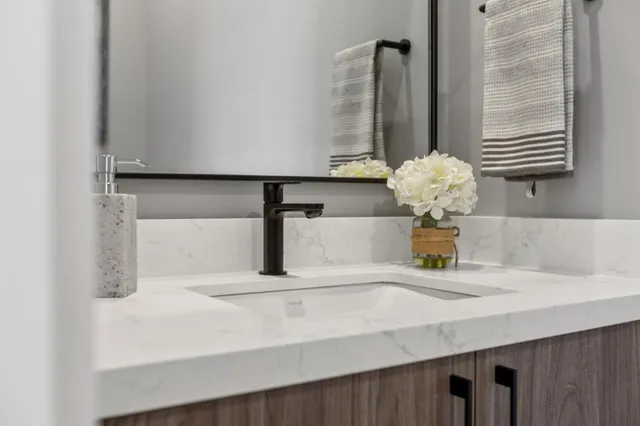 a kitchen with a sink and a mirror