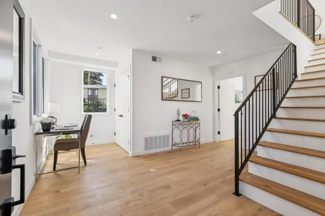 a view of a livingroom with furniture and staircase