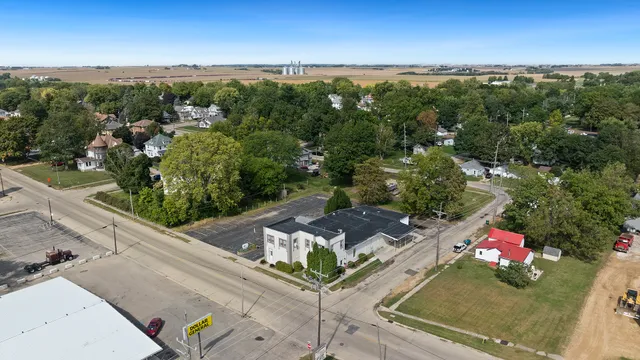 an aerial view of a swimming pool with lounge chairs