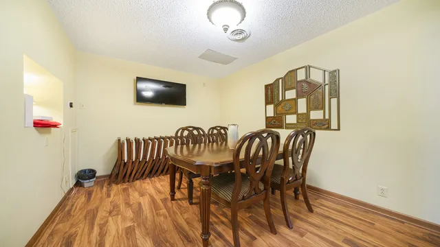 a view of a dining room with furniture and wooden floor