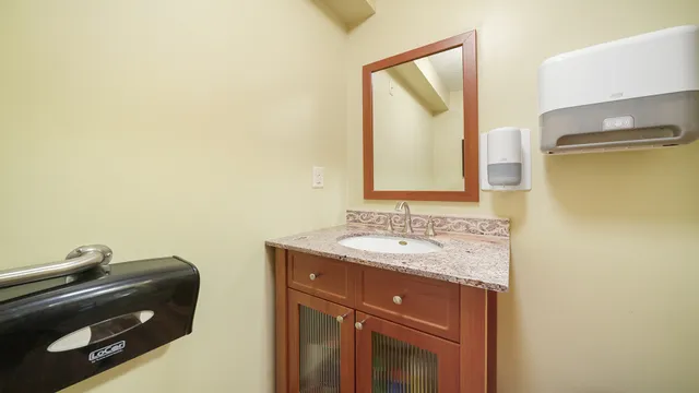 a bathroom with a sink a mirror and a vanity
