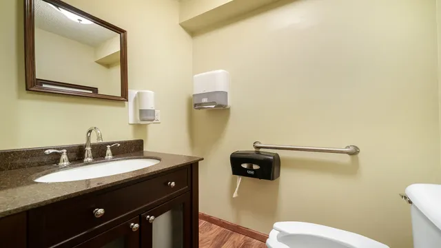 a bathroom with a granite countertop sink mirror and vanity
