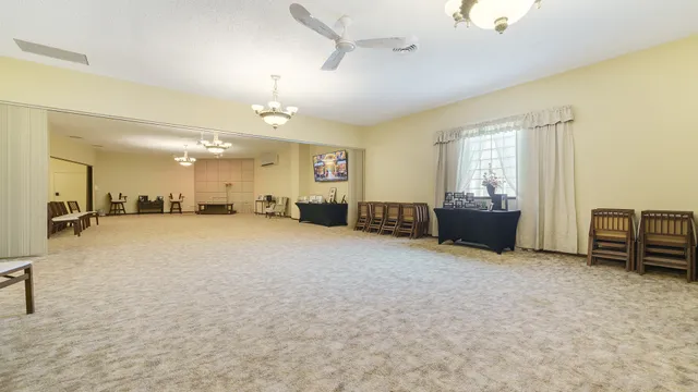 a view of a livingroom with furniture and a window