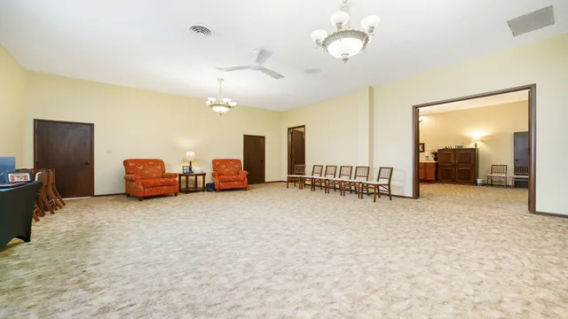 a living room with furniture and a chandelier
