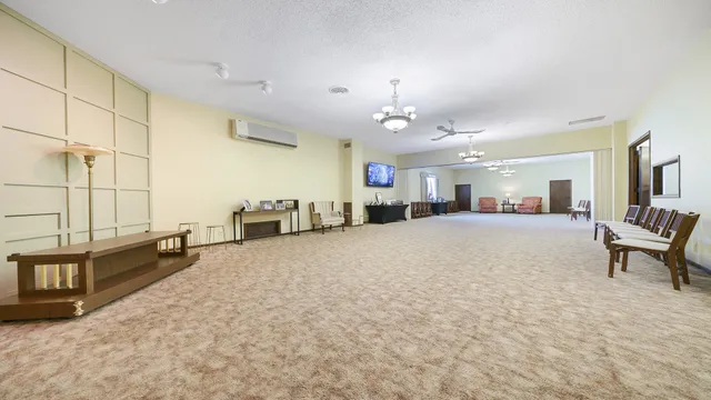a view of a livingroom with furniture and a ceiling fan