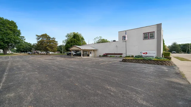 a backyard of a house with table and chairs