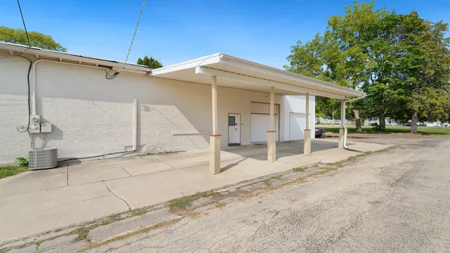 a backyard of a house with basket ball court