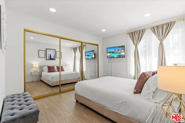 a view of a patio with table and chairs and potted plants with wooden floor