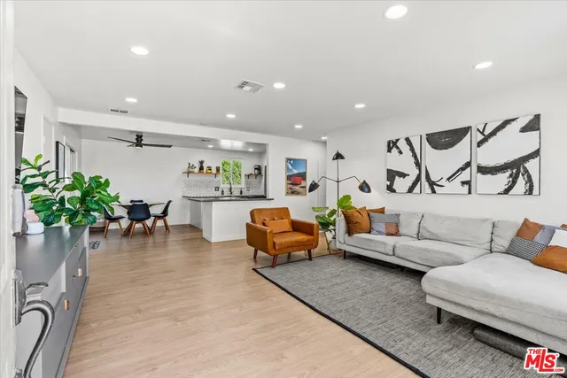 a living room with furniture and a potted plant
