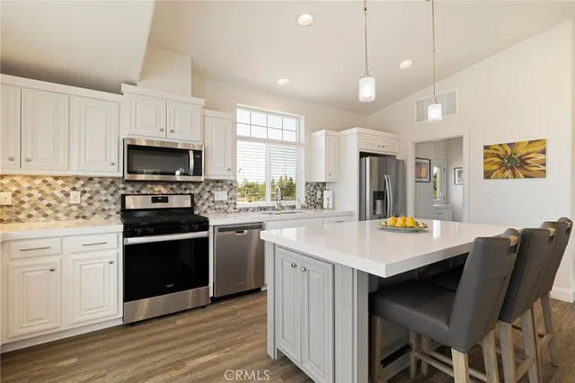 a kitchen with a stove a sink and a refrigerator