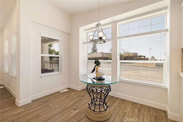 a dining room with wooden floor and a table