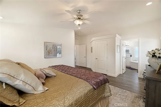 a spacious bedroom with a bed and a chandelier