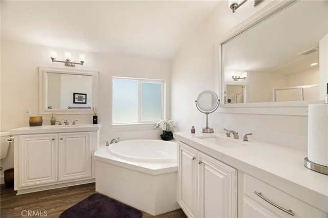 a bathroom with a tub sink and mirror