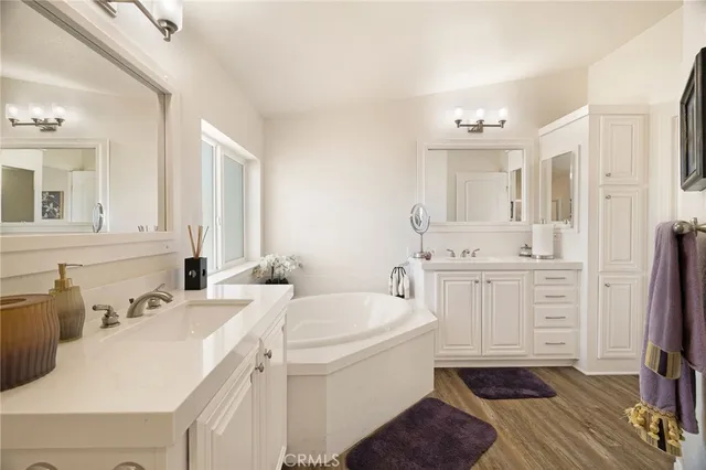 a bathroom with a sink a toilet a mirror and vanity