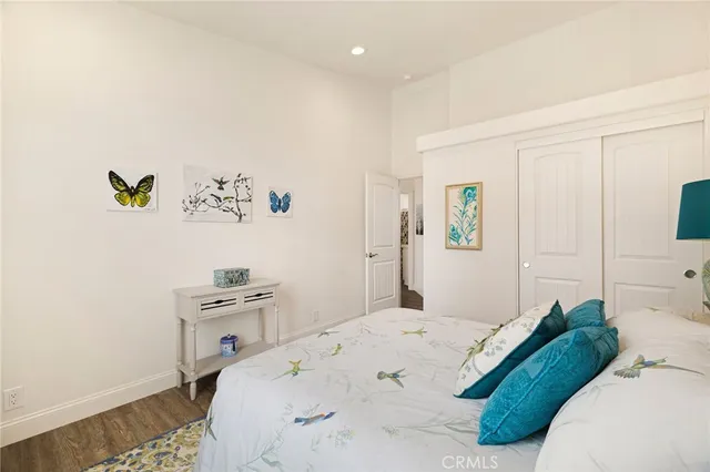 a bedroom with a bed dresser and a window