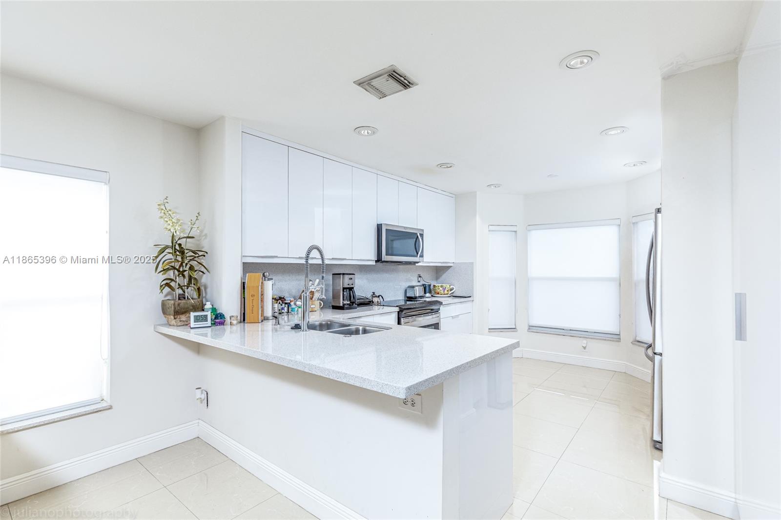 4913 Southwest 32nd Way Hollywood, FL 33312 - Photo 13 of 27 a kitchen with stainless steel appliances a sink a stove a refrigerator and cabinets