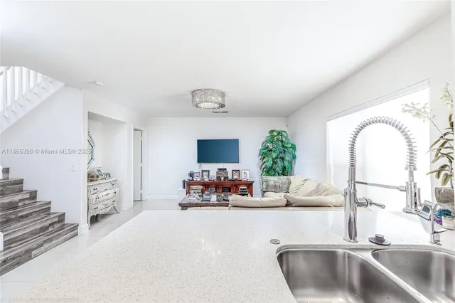 a kitchen with sink refrigerator and microwave