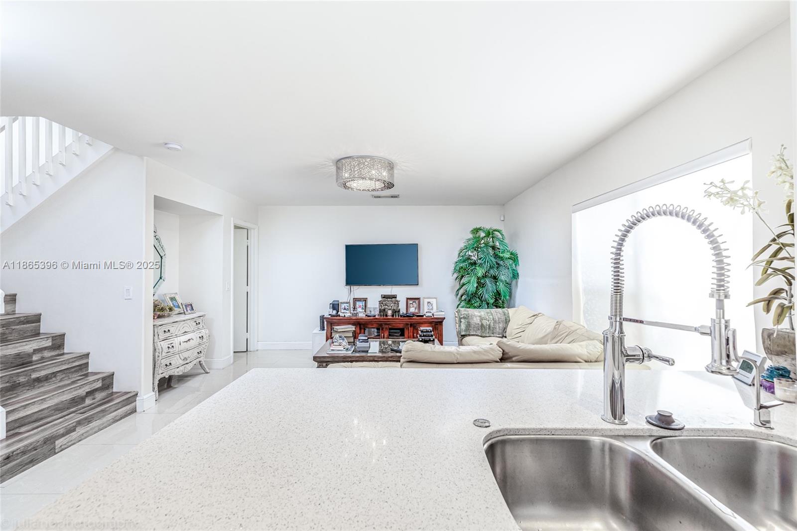 4913 Southwest 32nd Way Hollywood, FL 33312 - Photo 14 of 27 a kitchen with sink refrigerator and microwave