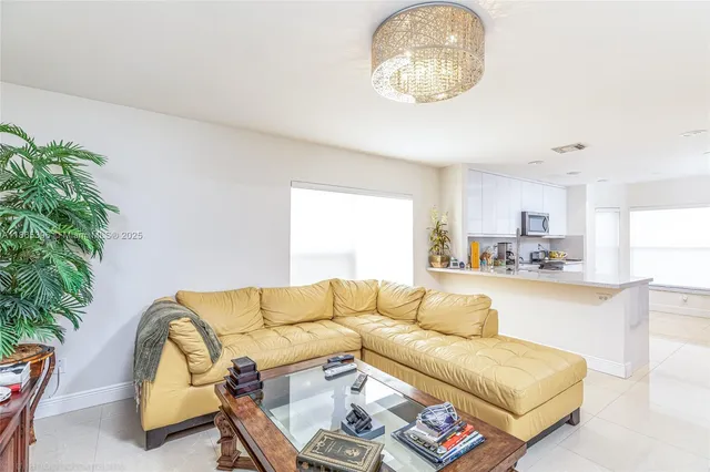 a living room with a couch and potted plant